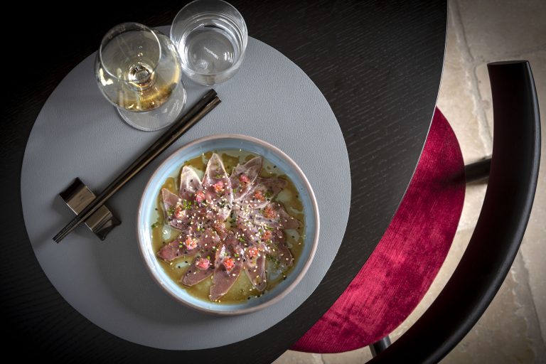 un piatto di sushi inquadrato dall'alto su un elegante tavolo